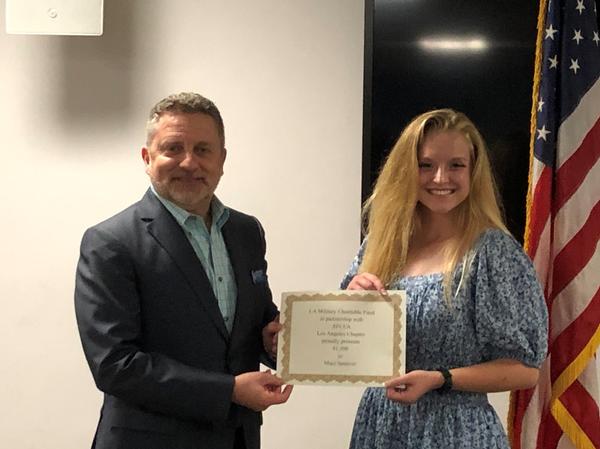Col Scott Beidleman, USAF (Ret), past chapter president, presents a scholarship certificate to Maci Spencer at the May event.