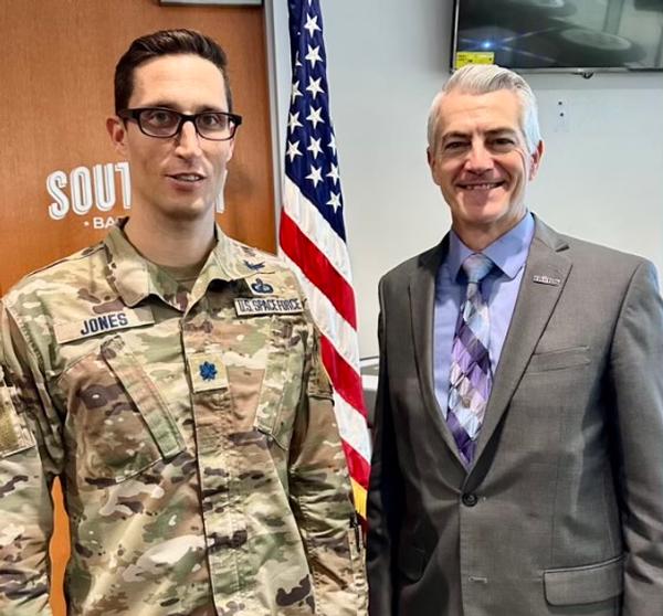 Col. (S) Edward E. Jones, USAF (l), poses for a photo with Todd Wiest, chapter vice president of programs, at the May event.