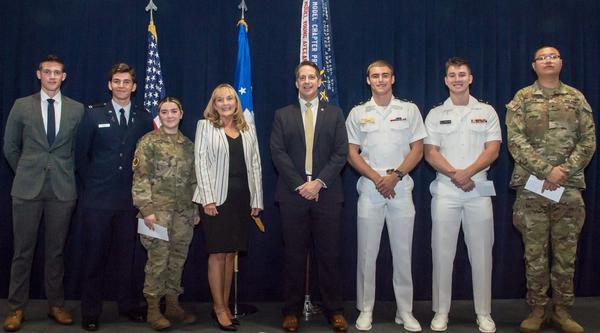 In September, (l-r) Cadet Malachi Anderson, Air Force ROTC at Loyola Marymount University; Cadet Nicolas Tapies, Air Force ROTC at University of Southern California (USC); Cadet Katherine Bonomo, Army ROTC at University of California at Los Angeles (UCLA); Joy White, Senior Executive Service executive director for Space Systems Command; Michael Plantenga, chapter president; Midshipman Matthew Merone, Navy ROTC at USC; Midshipman Hunter Streeter, Navy ROTC at UCLA; Cadet Andrew Shin, Army ROTC at USC, pose for a photo. Not pictured are Cadet Austin Holloway, Army ROTC at CSU, Fullerton and Cadet Nathan Padilla, Air Force ROTC at UCLA.