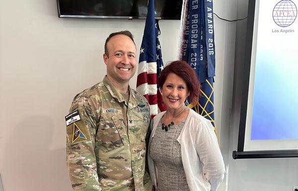 Jennifer Krolikowski, chapter vice president of finance, takes a photo with Col. Richard Kniseley, USSF, Space Systems Command's Commercial Space Office, at the April event.