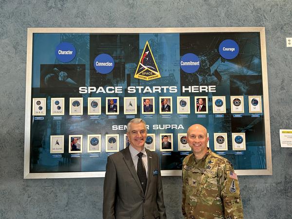 Col. Corey Klopstein, USSF, program executive officer for Operational Test & Training Infrastructure, Space Systems Command (r), and Todd Weist, chapter vice president of programs, pause for a photo at the May luncheon.
