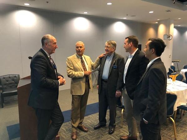 Pluntze (l) discusses the Remote Sensing Directorate with industry representatives at the July lunch/meeting in Los Angeles.