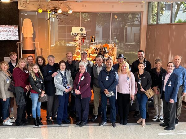 The chapter's board of directors poses with the Mars rover replica, including the helicopter, in December.