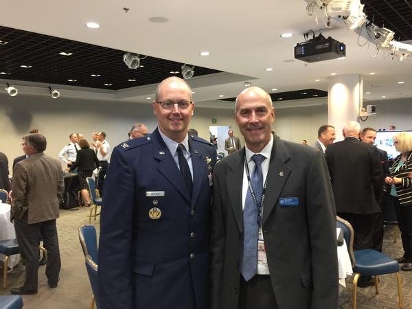 Page (r) greets Col. Whitney, a lunch speaker on the first day of the GPS Partnership Council in May.