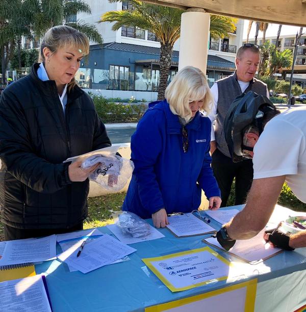 STEM volunteers sign in participants at the February event.