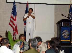 Rear Adm. Peter A. Gumataotao, USN, commander, U.S. Naval Forces Korea, speaks to more than 110 members and guests at the chapter's July luncheon.