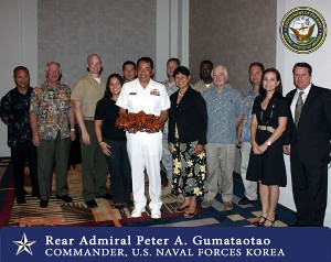 Attendees gathering at the July luncheon are (l-r) Mark Calvo; Lt. Gen. John Dubia, USA (Ret.); 1st Lt. Nathan Waters, USMC; Janae Certeza; Carl Aguon; Adm. Gumataotao; Maj. Duncan Leuenberger, USAF; Thelma Hechanova; Senior Chief Information Systems Technician Steven Dupree, USN; John Haft; Andy Miller; Sharon Cassidy; and Shayne Lambert.