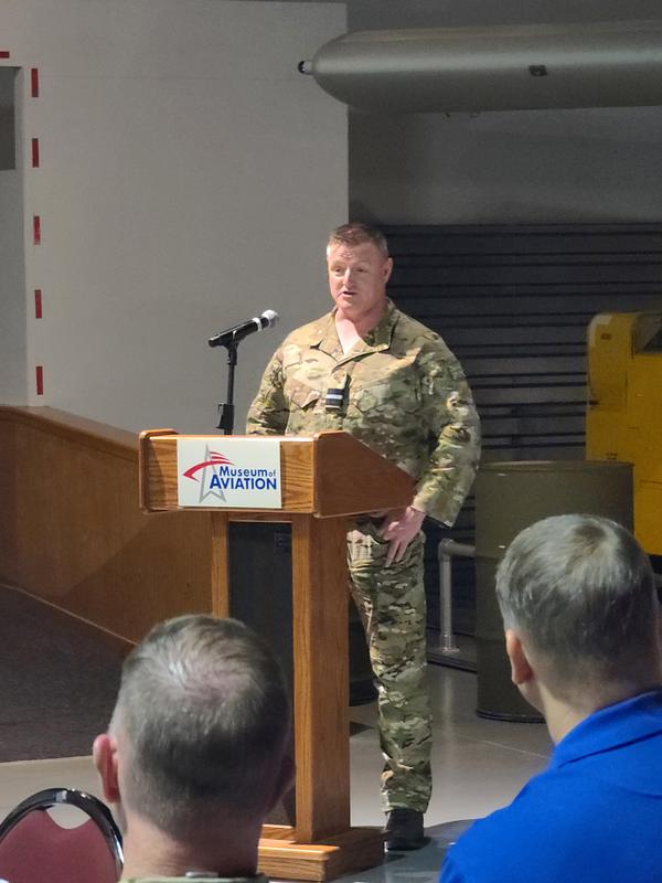 Air Commodore Jamie Thompson, RAF, speaks to the attendees of the May quarterly luncheon.