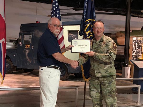 In May, Daniel Gillis, chapter vice president (l), presents a Certificate of Appreciation and Chapter Coin to Emerging Leader Capt. Caleb Bruce, USAF.