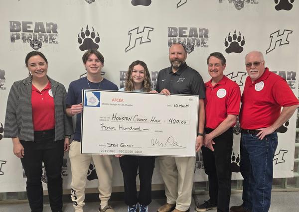 Darveau, Gillis and Alan Frost, chapter treasurer (second from far r), present faculty and students from Houston County High, Ethan Brown, Bianca Gibson and Jay Jones, principal, with an award check in March.