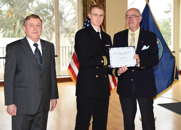 Naval Postgraduate School (NPS) President Vice Adm. Ronald Route, USN (Ret.) (l); award winner Lt. Andrew Moss, USN (c); and Chapter President Lawrence Reeves gather in the Barbara McNitt Ballroom at NPS to honor Moss in December.