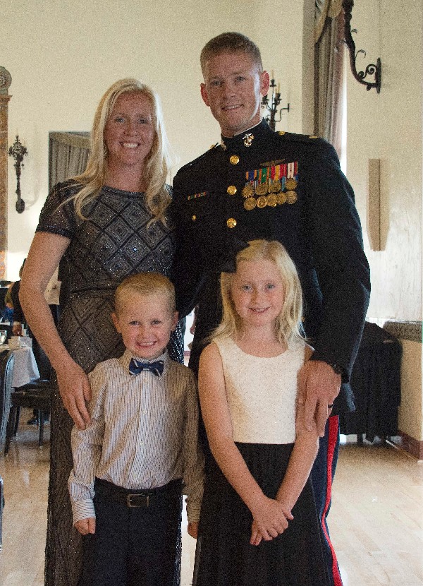 Maj. Adam Foushee, USMC, recipient of the AFCEA John McReynolds Wozencraft Award for Academic Excellence in Joint C4I, and his family attend the Midway Dining Out in June.