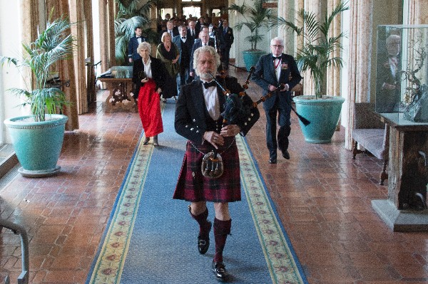 Dr. Edward Davis leads a parade down a hallway toward the Barbara McNitt Ballroom in the Naval Postgraduate School at the Battle of Midway Dining Out remembrance the chapter held in June with support from other organizations.  