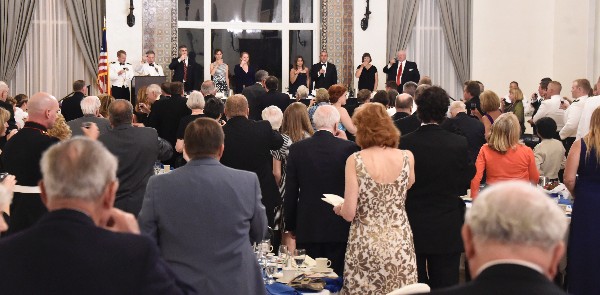 Participants at the June dinner stand for the toast to the commander in chief and farewell.