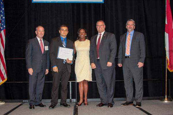 Chapter President Brian Knott (r) and Charisse Stokes, the chapter's Education Foundation director (c), present an Array scholarship and internship in May to Nicholas Homsher (2nd from l), with Richard Aldridge, program executive officer for Business and Enterprise Systems, Maxwell-Gunter Annex, Alabama (2nd from r), and an Array representative.  