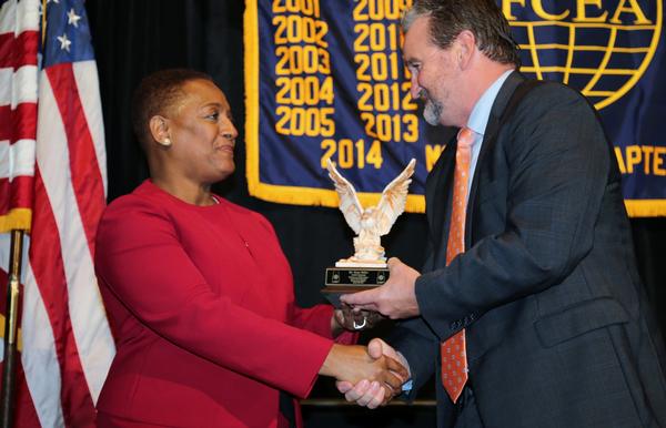 Brian Knott, chapter president (r), presents Essye Miller, the Defense Department's deputy chief information officer for cybersecurity, a token of appreciation for speaking at the annual awards banquet in August.