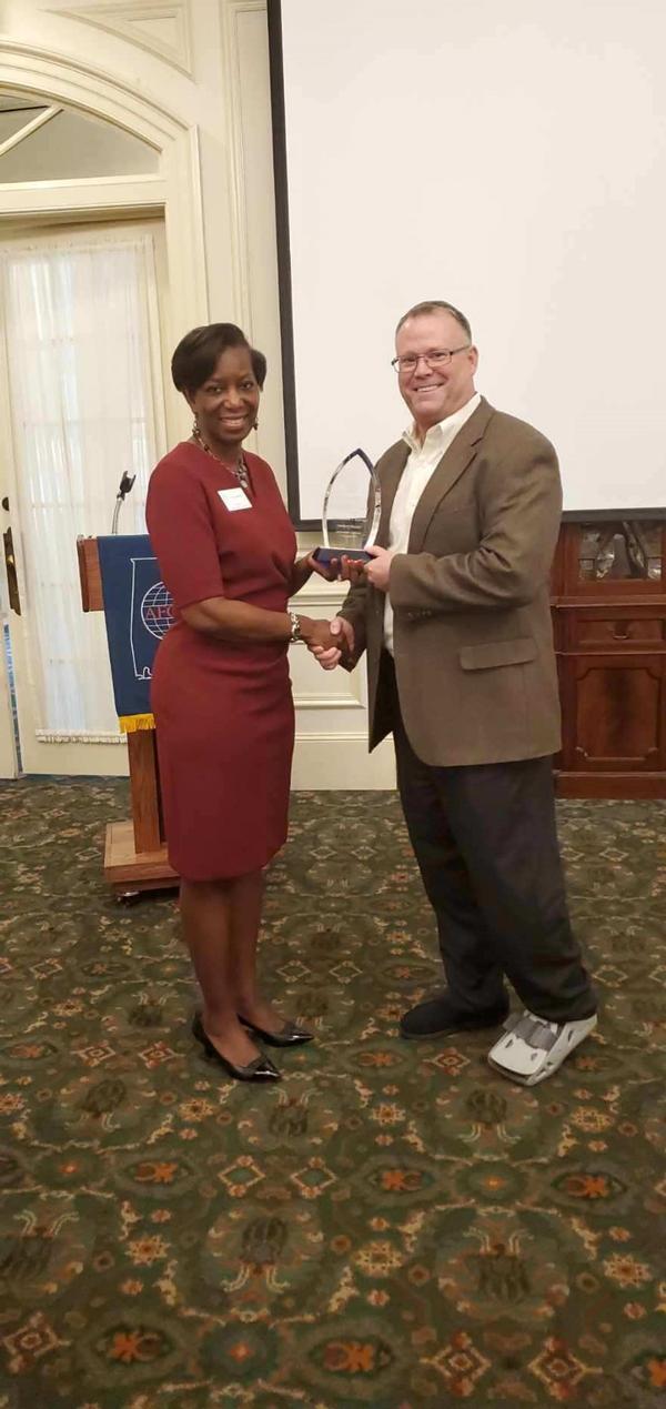 Col. Kyna Paster, USAF (Ret.), chapter president, presents Richard Aldridge, program executive officer (PEO) for Business and Enterprise Systems (BES) with a token of the chapter's appreciation for speaking at the November luncheon.
