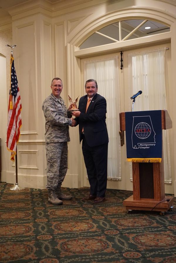 Brian Knott, chapter president (r), presents guest speaker Col. Rick "Rico" Johns, USAF, deputy director for air, space and cyberspace operations and chief information officer, Headquarters Air Force Materiel Command, with a token of the chapter's appreciation for his presentation at the event in November.