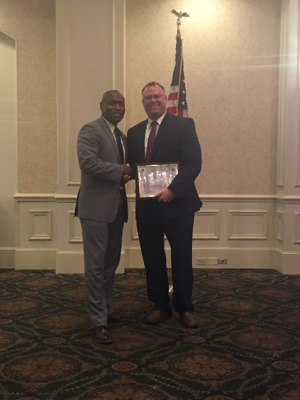 Eric Sloan, chapter president (l), presents guest speaker Richard Aldridge, program executive officer (PEO) for Business and Enterprise Systems (BES), with a token of appreciation at the December chapter luncheon.