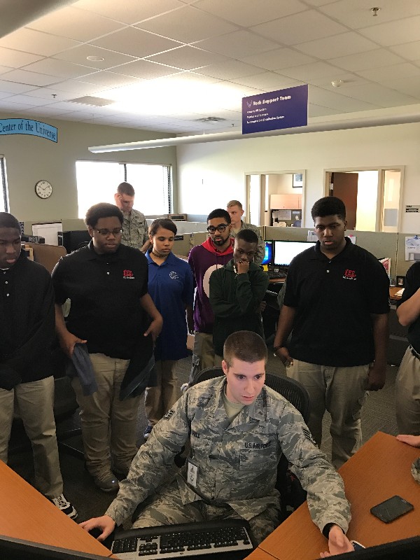 During the chapter's March Job Shadow Day, a U.S. Air Force staff sergeant (front, c) shows Robert E. Lee High School students how to remotely shut down a computer.