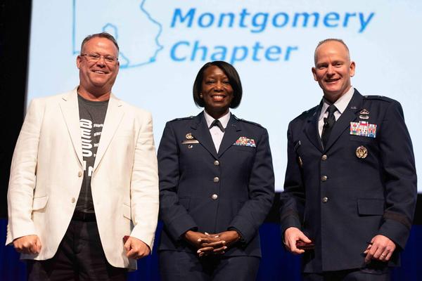 Col. Kyna McCall, USAF, chapter president (c), thanks Richard Aldridge, program executive officer (PEO), Business and Enterprise Systems (BES), Maxwell Air Force Base, Gunter Annex, Alabama (l); and Brig. Gen. Michael Schmidt, USAF, PEO, Command, Control, Communication, Intelligence and Networks, for their keynote briefings at the May event.