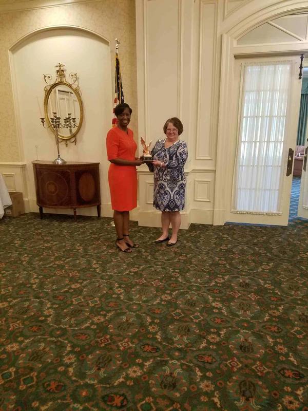 Col. Kyna McCall, USAF (Ret), chapter president, presents Tanya Lambert, chief, Business Transformation, Business and Enterprise Systems Directorate (BES), with a token of the chapter's appreciation at the September event.