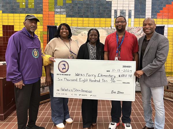 In November 2024, Education Foundation Director Eric Sloan (r) presents a STEM/Robotics donation to faculty from the Wares Ferry Elementary School in Montgomery, Alabama.