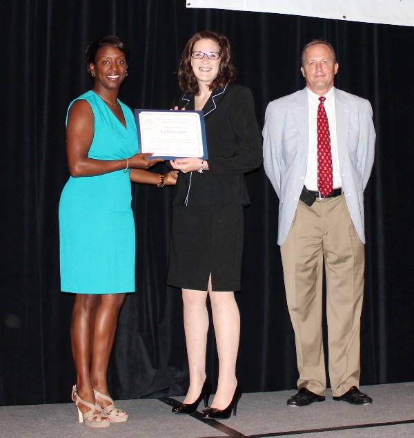 In June, Kaitlan Cooper (c), a rising senior at Auburn University Montgomery, accepts her Education for Industry Scholarship from Stokes and Besselman.