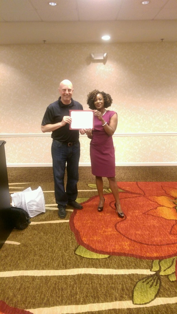 Kameke Mitchell (r), president of the Young AFCEAN chapter, presents Wojszynski with a certificate of appreciation for speaking at the April Business Over Breakfast.