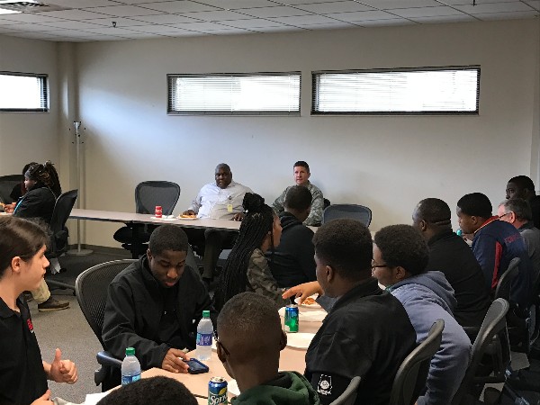 Herbert Hunter, director of staff, Business Enterprise Systems (BES) (c, l), and Col. Michael Jiru, USAF, deputy director of BES (c, r), talk to students at lunch during Job Shadow Day. 
