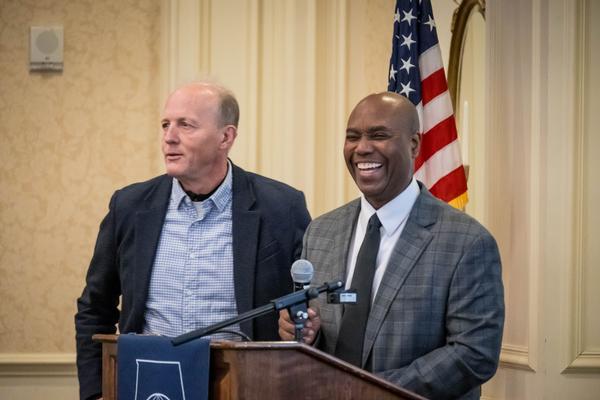 Joseph Besselman, chief disruption officer, U.S. Air Force (l), plays the role of anger translator as Burse presents program status during the January event.