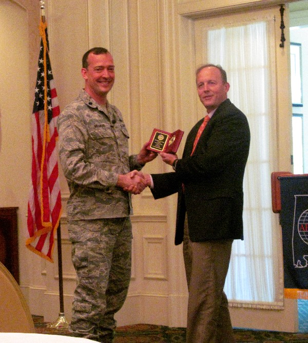 Joe Besselman, chapter president, presents Lt. Col. Paul Williams, USAF, commander, 26th Network Operations Squadron, with a gift in appreciation for donating his time to speak at the April luncheon.