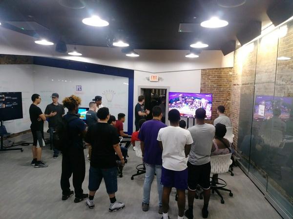 Players gather to watch teams compete at Super Smash Bros. during the May esports event.