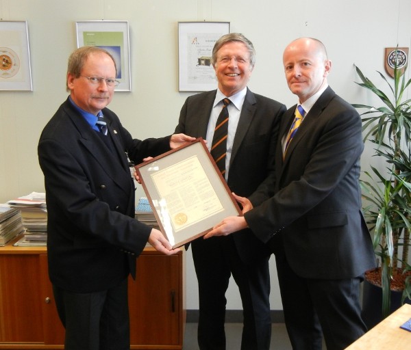 In February, Klaus-Peter Treche (c), president of AFCEA Europe, and Markus Reigl (r), outgoing chapter president, present the incoming chapter president, Theodor Kowalski, with the chapter's authenticated founding charter.