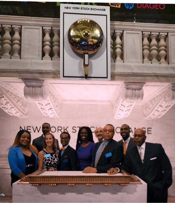 The AFCEA Blacks on Wall Street (BoWS) Team poses for a photo after the closing bell on the New York Stock Exchange trading floor in June.