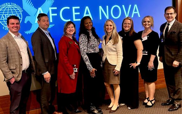 Darlene Bullock, executive director of the Office of Small Disadvantaged Business Utilization at the U.S. Department of Homeland Security (c), poses for a photo with members of the chapter's Small Business Committee in November.