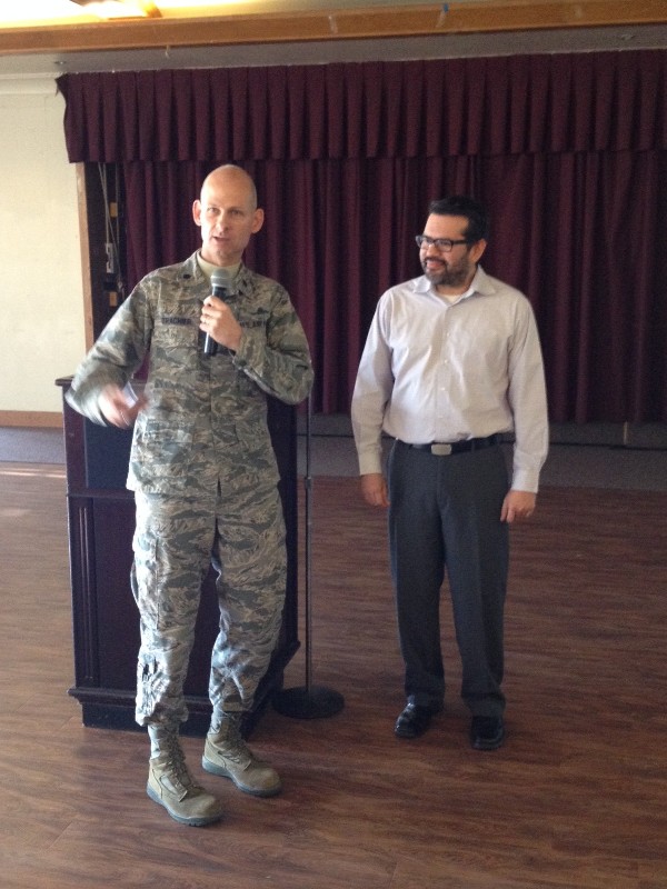 Mario Sanchez (r), a registered communications distribution designer with Bergelectric Corporation, receives a thank you coin from Lt. Col. James Trachier, USAF, chapter president, following Sanchez's presentation on information technology design at the December luncheon.