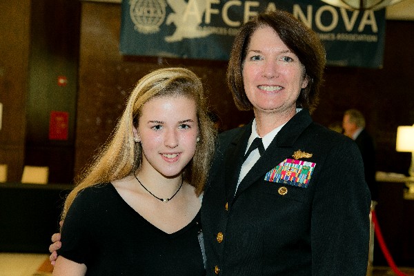 Rear Adm. Nancy Norton, USN, director of warfare integration for information warfare (OPNAV N2/N6F), meets national anthem signer Emma Lay at the October luncheon.