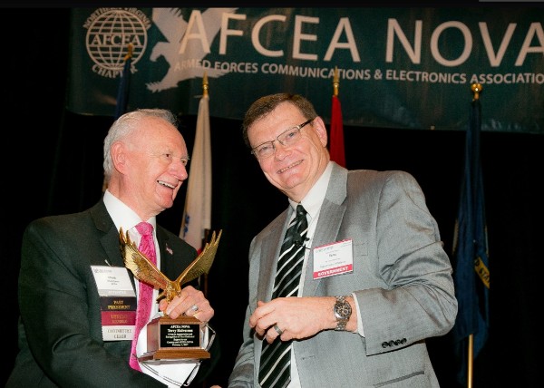 Chapter Past President Chuck Corjay (l) presents the AFCEA Special Recognition Gold Eagle Award in February to Terry Halvorsen, Defense Department chief information officer, for his support of the chapter. Halvorsen retires from his post February 28. 