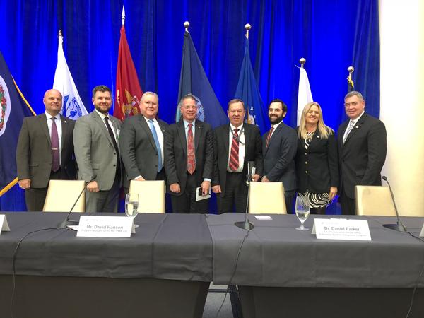 Panelists and others participating in a November chapter luncheon focused on logistics modernization gather for a photo.