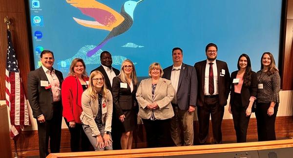 AFCEA NOVA Small Business Breakfast attendees (l-r) Sean Caulfield, Michele Myers, Anneli Connell, Larry Massey, Susan Caulfield, Chuck Griffith, Blake Harvey, Polly Mineva and Alison Gonzalez with Kimberly Buehler pose for a photo.