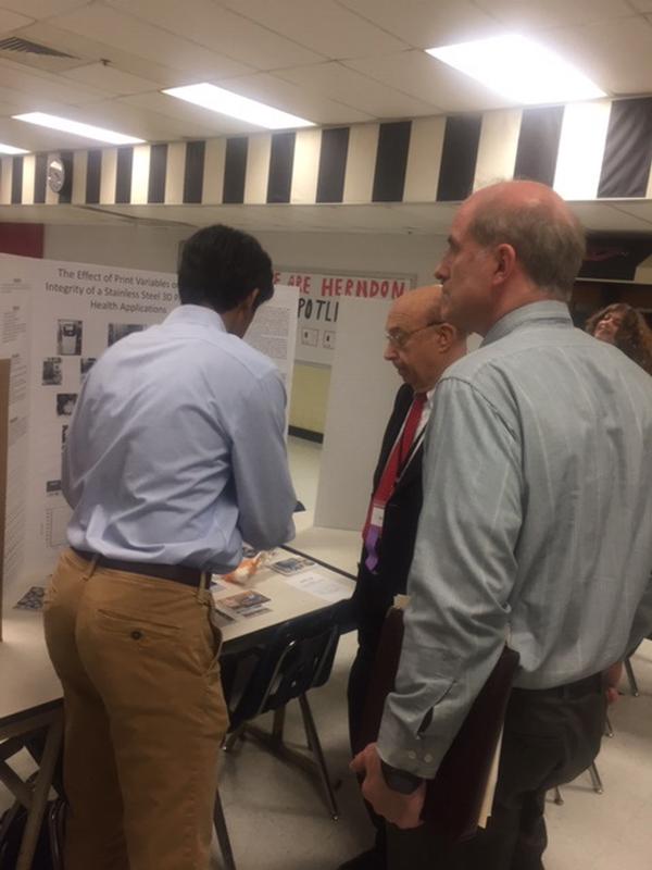 Chapter members recommend first and second place awards during the Herndon High School Science Fair in February.