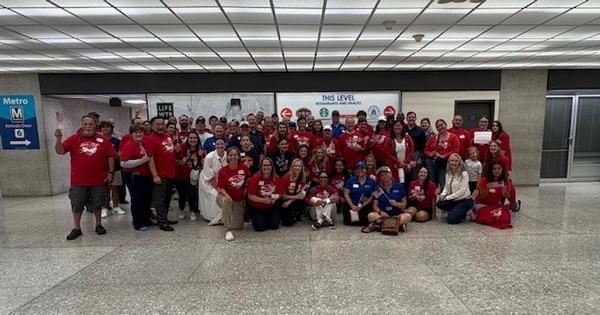 In July, Honor Flight volunteers gather to meet the veterans with cheers and recognition.