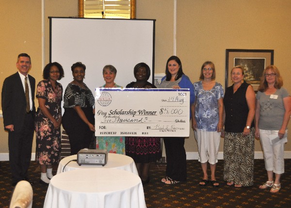 In August, Paul Reimers (l), chapter president, and Georgia Popp (r), vice president of the chapter's STEM Program, present grants ranging from $500 to $1,000 to local teachers for science, technology, engineering and mathematics.