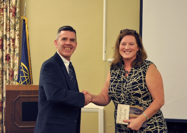 Chapter President Paul Reimers thanks Kimrey Rhinehardt, vice president for federal relations for the University of North Carolina (UNC) system, who spoke at the chapter's November luncheon about the growing relationship between the armed forces and UNC.