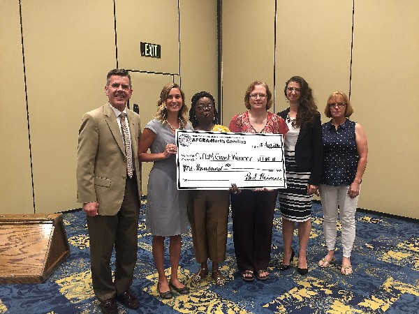 Chapter President Paul Reimers and Georgia Popp, chapter vice president, Science, Technology, Engineering and Mathematics (STEM) Program (r), recognize $1,000 grant winners in August, including (l-r) Megan McMillen of Pine Forest Middle School; Nadyne Wilds-Gilbert of Lewis Chapel Middle School; Barbara White of Glendale Acres Elementary School; and Stephanie Spangler of New Century International Middle School.