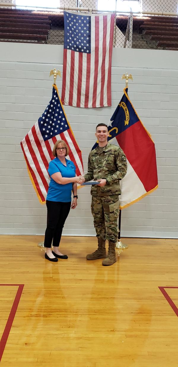 Chapter representative Georgia Popp presents Cadet Elijah Paynter, junior ROTC, East Carolina University, the AFCEA International ROTC Honors Award for 2019 in recognition of his achievements in leadership and academics at the March event. 