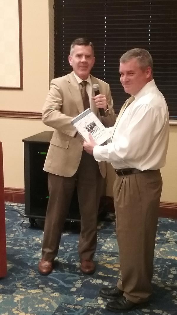 Chapter President Paul Reimers (l) gives a token of appreciation to Fitzgerald at the September luncheon.