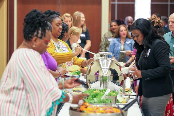 Educators enjoy the luncheon hosted by the chapter in August.