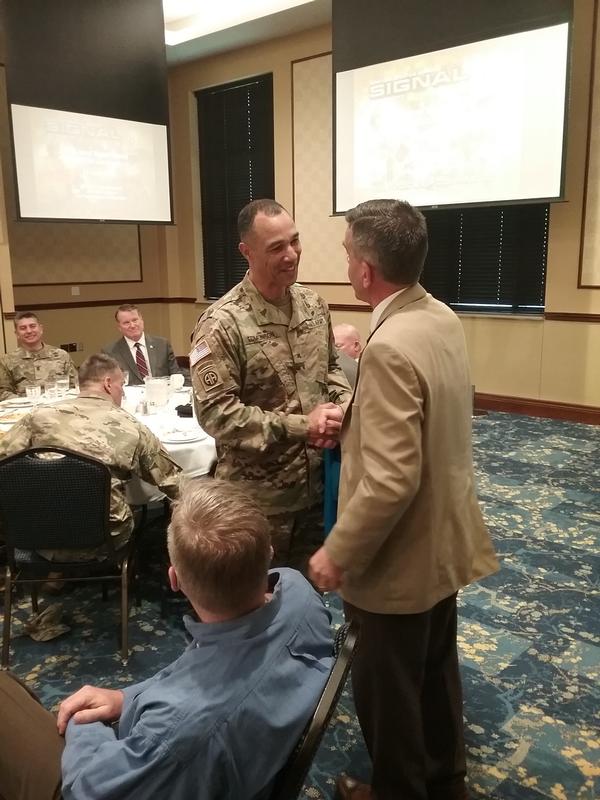 Reimers (r) presents Gen. Edmonson a chapter golf shirt and coins as tokens of appreciation for speaking at the June luncheon.